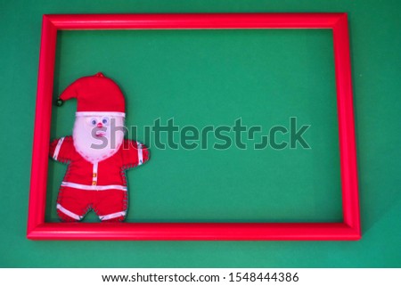 
Santa Claus stands in a red frame
