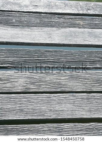 This wood grain picture is a pier of a house beside the canal.