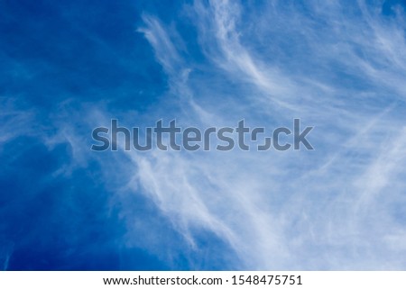 High white wispy cirrus clouds with cirro-stratus in the blue Australian sky  sometimes called mare's tails indicate fine weather now but stormy changes coming within a couple of days.