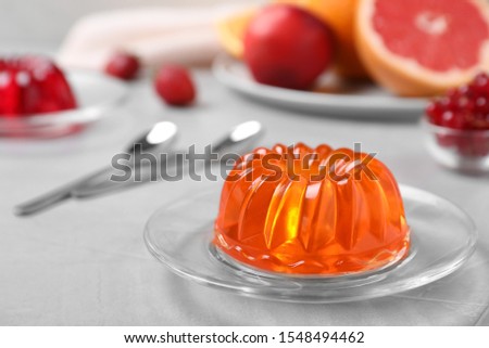 Delicious fresh orange jelly on grey table