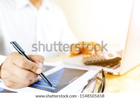 Business accounting plan concept, Working on desktop laptop computer with calculator for making business, business man hand working with laptop computer on wooden desk business investment advisor.