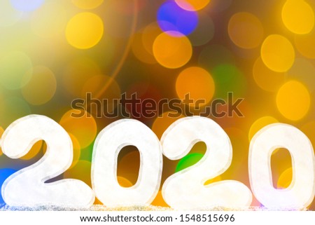 Happy new year 2020 isolated on black background with copy space for text, for holiday card. Blurred snowflakes, snow.