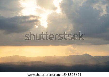 Beautiful strom rain clouds with sunrays at sunset