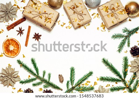 Christmas pattern with pine cones, fir branches, shiny balls, gift boxes, star anise, dried orange and confetti. Top view, flat lay, copy space.