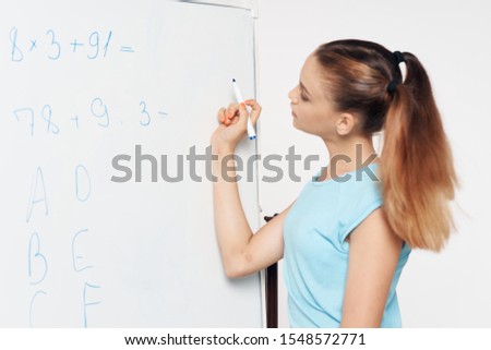 Girl near a school board learning a school lesson
