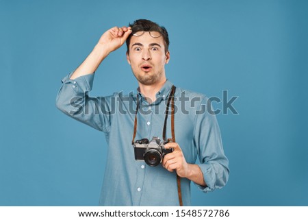 man in blue shirt camera travel lifestyle entertainment