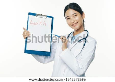 happy female doctor shows finger on documents in hand