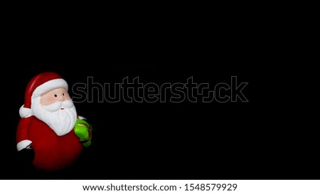 Toy Santa Claus on a black background.