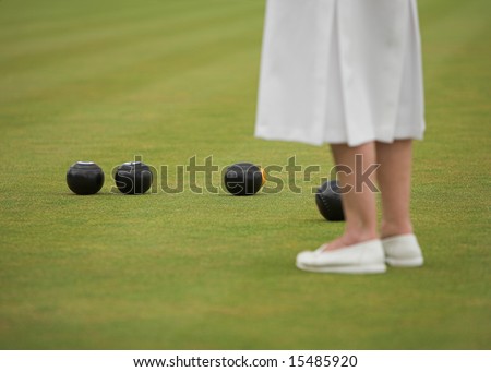 Lady player in a game of lawn bowls.