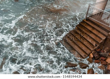 A staircase descending into the sea
