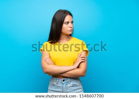 Young girl over isolated blue background portrait