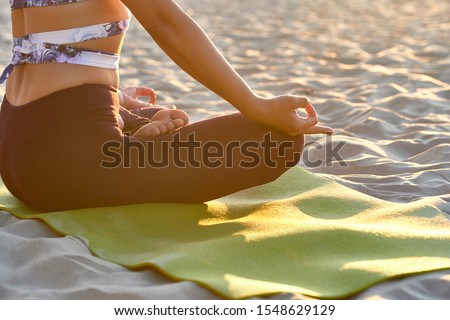 Fitness woman doing yoga exercise and relax with sportswear in the sea at summer, healthy lifestyle concept Close up photo Modern for lifestyle design. Healthy fitness background. Body relaxation.