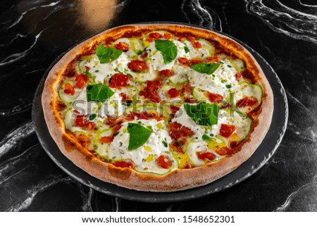 Traditional italian pizza pepperoni with salami and cheese on a dark slate, stone, metal or concrete background.Top view with copy space.
