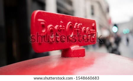Old red cast iron sign to the Post Office in London, UK