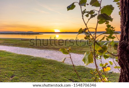sundown scenery at Lake Neusiedl near Podersdorf am See in Burgenland in Austria Royalty-Free Stock Photo #1548706346