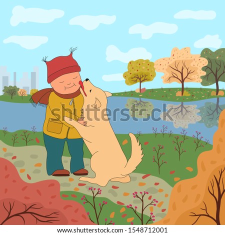 Little boy in warm clothes walking with a dog on the background of the autumn landscape. The dog licks the baby's cheek. Friendship with a pet.