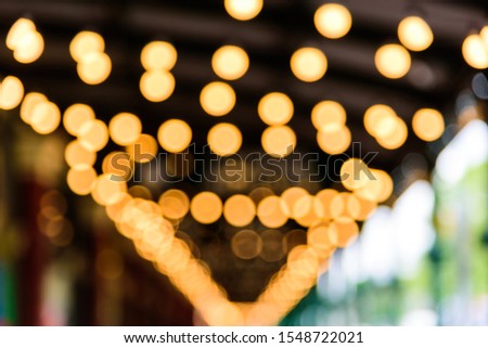 Rows of illuminated globes under the marquee as is often used at the entrance to theatres and casinos
