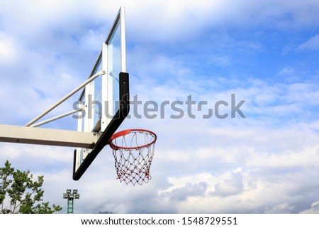 Basketball hoop in outdoor basketball field with blue sky