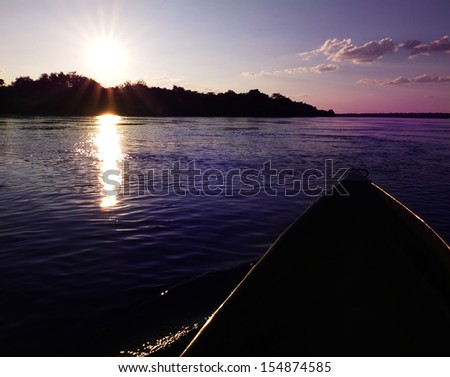 Mokoro canoe trip - traditional tourist attraction in Botswana and northern Namibia (here - during the sunset in Caprivi Strip)