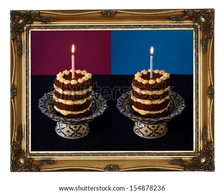 Chocolate birthday party backed cake with vanilla cream and burning candle on antique stand with blue pattern, purple, golden antique carved picture frame isolated on white background