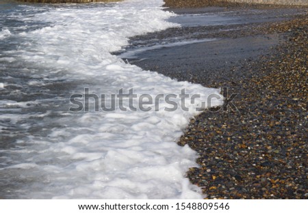sea wave foams. Trace from the motor of a marine vessel on the surface of the sea, beautiful nature background
