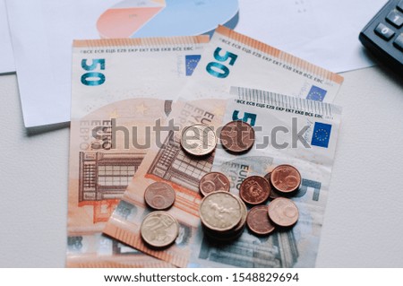 Step of coins stacks with notebook laptop computer and financial graph on white paper on working table, business planning vision and finance analysis concept idea. 