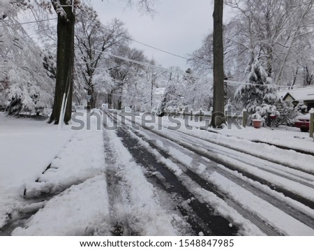 Road after snow storm with car tracks