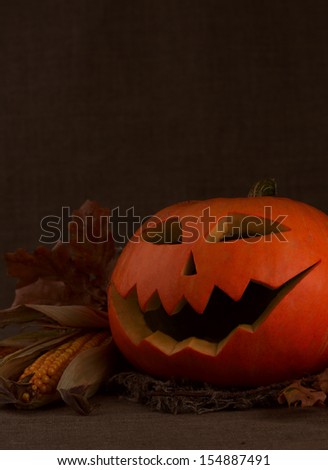 Scary halloween pumpkin jack-o-lantern on dark background