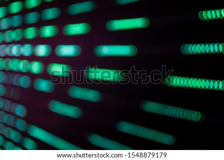 Abstract beautiful blurry or softy bokeh of LED lighting. Group of blurry multi green color ornamental lights flickering. Background for digital data transformation or energy saving or Sci-fi concept.