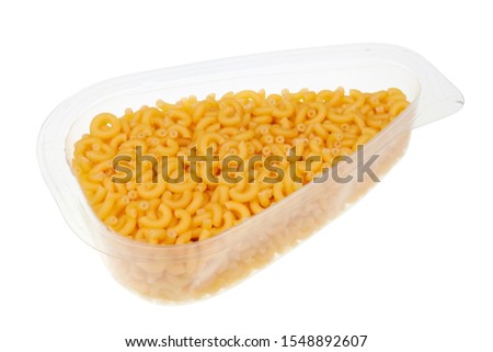 Daily food product - small pasta in a transparent plastic container. Isolated with patch  on white studio macro