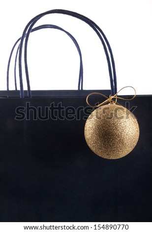 Shopping bag decorated with a sparkling gold Christmas bubble
