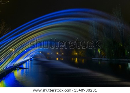long exposure night fountain with blue and yellow colors spotlight illumination 