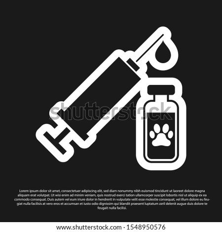 Black Syringe with pet vaccine icon isolated on black background. Dog or cat paw print