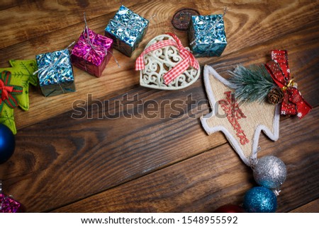 Beautiful Christmas toys on the holiday tree on a wooden vintage table
