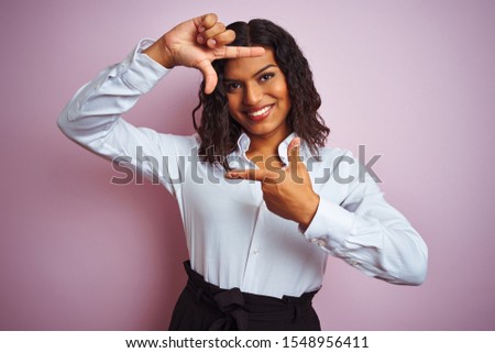 Beautiful transsexual transgender elegant businesswoman over isolated pink background smiling making frame with hands and fingers with happy face. Creativity and photography concept.