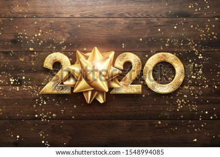 Golden New Year 2020 sign on a wooden background. happy new year, merry christmas