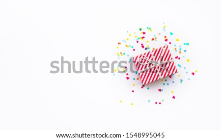 Celebration anniversary and party concepts ideas with colorful gift box present and confetti element on white color background.Top view design template and copy space