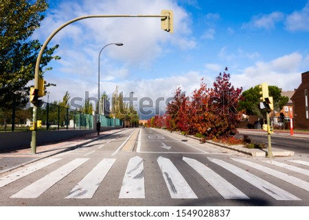 PEDESTRIAN STEP AND SEMAPHORE IN STREET OF MADRID ON BLUE SKY WITH CLOUDS Royalty-Free Stock Photo #1549028837