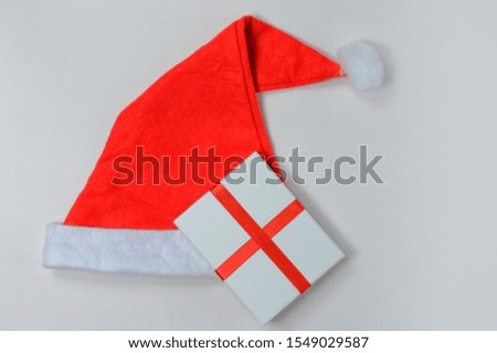 Santa hat with gifts on a light background