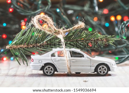 Christmas tree on car. Small toy car. Christmas concept.