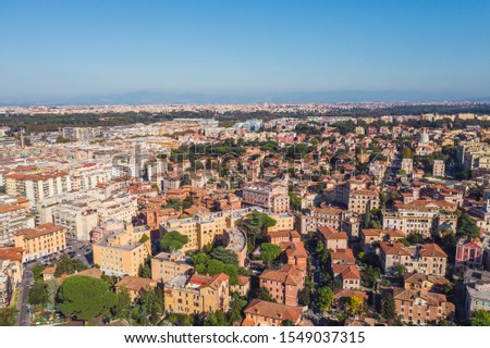 Residential area with buildings in Rome, Italy. Many orange and yellow houses, Aerial view from drone.