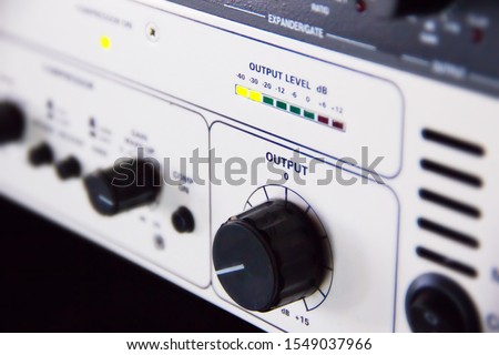 A rack of audio compressors and other components of sound reinforcement system in a recording studio close up. Making music in the professional studio. Output knob and sound level control macro