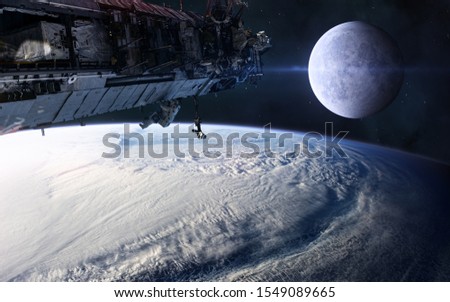 ISS on background of the moon and the terrestrial landscape. Solar system. Science fiction. Elements of this image furnished by NASA