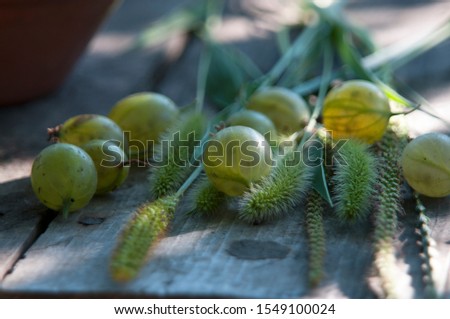 
gooseberries in a plate on a wooden table