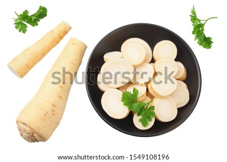 fresh parsley root with slices and parsley in a black plate isolated on white background. top view