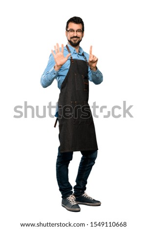 Full-length shot of Man with apron counting six with fingers over isolated white background