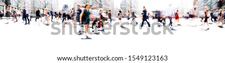 Lots of business people walking in the City of London. Blurred image, wide panoramic view of the road with people at sunny day. London, UK