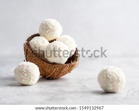 Coconut healthy sugarfree bliss balls in coconut shells on gray white background Royalty-Free Stock Photo #1549132967