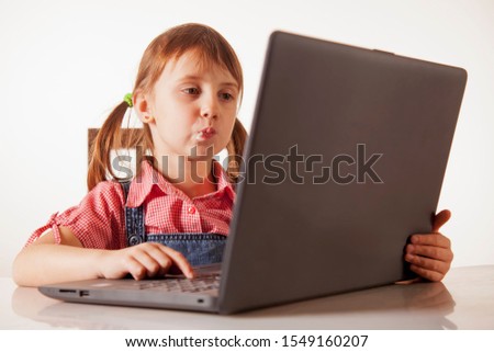 Humorous photography of beautiful young girl programmer working with laptop