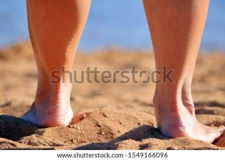 Woman on the beach by the lake